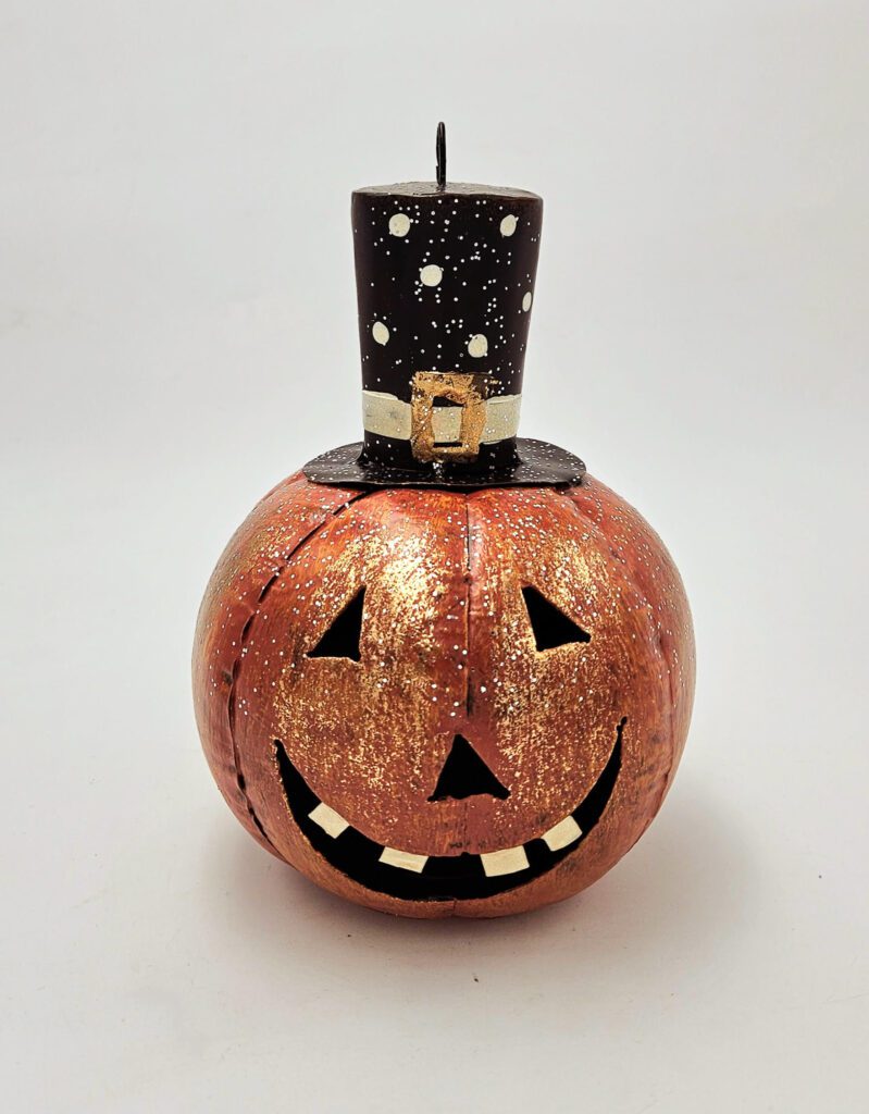 This spooky and sweet metal jack-o-lantern with a jaunty buckle hat is ready to hang anywhere! One electric fairy light pack is included.

This product does not include a candle. This listing is for the Buckle Hat Pumpkin only.